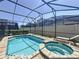 Enjoy this beautiful screened-in pool and hot tub with plenty of space for entertaining and relaxing on sunny days at 1612 Herrons Green Path, Kissimmee, FL 34747