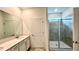 Bright bathroom boasts double vanity, large mirror, and a walk-in shower at 17112 Salty Dog Rd, Winter Garden, FL 34787