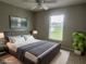 Virtually staged bedroom with gray bedding and large window at 413 Cardinal Ct, Kissimmee, FL 34759