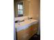 Modern bathroom featuring double sinks, wooden cabinets, and ample counter space at 14421 Hatchee Ct, Orlando, FL 32837