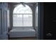 Bathroom with a large tub under an arched window, providing a relaxing space with plenty of natural light at 14421 Hatchee Ct, Orlando, FL 32837