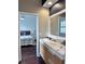 Elegant bathroom with double sinks, modern fixtures, and bedroom view at 14421 Hatchee Ct, Orlando, FL 32837