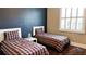 Cozy bedroom featuring two twin beds with matching linens and a window with shutter blinds at 14421 Hatchee Ct, Orlando, FL 32837