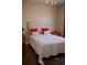 Inviting bedroom with a striped headboard, red pillows, and hardwood floors at 14421 Hatchee Ct, Orlando, FL 32837