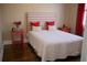 Bright bedroom with accent headboard, two side tables, and hardwood flooring at 14421 Hatchee Ct, Orlando, FL 32837