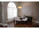 Elegant dining room featuring a dark wood table, white chairs, and large arched window at 14421 Hatchee Ct, Orlando, FL 32837