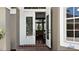 Elegant double doors open to reveal a glimpse of the home's interior, showing hardwood floors and a chandelier at 14421 Hatchee Ct, Orlando, FL 32837