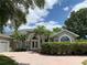 Charming home featuring a beautiful front yard, complemented by well-maintained landscaping and double door entrance at 14421 Hatchee Ct, Orlando, FL 32837