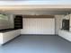 Spacious garage featuring built-in cabinets, ample storage, and a clean, epoxy-coated floor at 14421 Hatchee Ct, Orlando, FL 32837