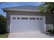 Modern garage door with decorative windows, enhancing the curb appeal of this well-maintained home at 14421 Hatchee Ct, Orlando, FL 32837
