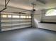Spacious garage featuring a workbench and storage cabinets, perfect for projects and organization at 14421 Hatchee Ct, Orlando, FL 32837