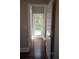 Hallway with hardwood floors leading to a door with glass panels at 14421 Hatchee Ct, Orlando, FL 32837