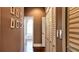 Bright hallway with closet and decorative pictures leading to a naturally-lit bathroom at 14421 Hatchee Ct, Orlando, FL 32837