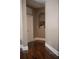 Hallway featuring wood floors, neutral paint, and an arched decorative niche at 14421 Hatchee Ct, Orlando, FL 32837