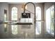 Modern kitchen features a sleek faucet and granite countertops, complemented by a view of the dining area at 14421 Hatchee Ct, Orlando, FL 32837