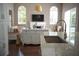 View of granite kitchen island, stainless sink, and breakfast bar with view to the Gathering room at 14421 Hatchee Ct, Orlando, FL 32837
