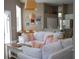 Cozy living room featuring white furniture and decor with view of the breakfast nook and kitchen at 14421 Hatchee Ct, Orlando, FL 32837