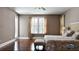 Bright main bedroom featuring hardwood floors, large windows, and access to the lanai at 14421 Hatchee Ct, Orlando, FL 32837