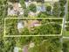 Expansive property with mature trees, as seen from an aerial view with property lines at 1775 Sundance Dr, St Cloud, FL 34771