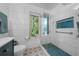 Modern bathroom with a glass shower, decorative tiles, and natural light at 1775 Sundance Dr, St Cloud, FL 34771