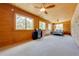 Large bedroom with wood paneling, and carpeted floor at 1775 Sundance Dr, St Cloud, FL 34771