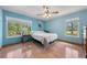 Serene bedroom with calming blue walls, wood floors, and ample natural light at 1775 Sundance Dr, St Cloud, FL 34771