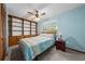 Comfortable bedroom with built-in shelving, ceiling fan, and a large window view at 1775 Sundance Dr, St Cloud, FL 34771