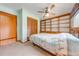 Comfortable bedroom with a ceiling fan, built-in shelving, and closet with wood-slatted doors at 1775 Sundance Dr, St Cloud, FL 34771