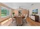 Dining room with hardwood floors, large windows, and neutral-toned furniture at 1775 Sundance Dr, St Cloud, FL 34771