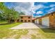 Traditional brick home featuring an oversized driveway and a 3-car garage at 1775 Sundance Dr, St Cloud, FL 34771