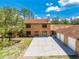 Two-story brick home with a long driveway and attached garage offering curb appeal and ample parking at 1775 Sundance Dr, St Cloud, FL 34771