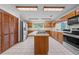 Spacious kitchen with ample oak cabinets, a center island, and stainless steel appliances at 1775 Sundance Dr, St Cloud, FL 34771
