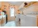 Functional laundry room with a washer, dryer, utility sink, and convenient storage shelves at 1775 Sundance Dr, St Cloud, FL 34771