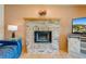 Inviting living room features a brick fireplace and hardwood floors at 1775 Sundance Dr, St Cloud, FL 34771
