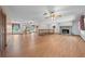 Spacious living room boasts a brick fireplace, wood floors, and ample natural light at 1775 Sundance Dr, St Cloud, FL 34771