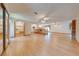 Large living area with wood floors, multiple ceiling fans, and access to a closet with organizers at 1775 Sundance Dr, St Cloud, FL 34771