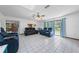 Inviting living room with tile floors, a ceiling fan and plush reclining furniture at 1775 Sundance Dr, St Cloud, FL 34771