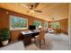 Cozy home office with wood-paneled walls and multiple windows offering natural light at 1775 Sundance Dr, St Cloud, FL 34771
