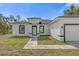 Charming single-story home featuring a black and white color scheme and well-manicured lawn at 2396 Sw 147Th Lane Rd, Ocala, FL 34473