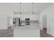 Modern kitchen boasts stainless steel appliances, a center island, and sleek white cabinetry at 2396 Sw 147Th Lane Rd, Ocala, FL 34473