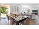 Elegant dining area with a large table, stylish seating, and sliding glass doors for seamless indoor-outdoor flow at 500 Summit River Dr, Apopka, FL 32712