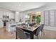 Open-concept dining area featuring modern furnishings, an adjacent kitchen island, and plenty of natural light at 500 Summit River Dr, Apopka, FL 32712