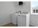 Laundry room features white washer and dryer units and wire shelving at 500 Summit River Dr, Apopka, FL 32712