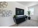 Modern living room featuring a sleek console, a large TV, and contemporary decor at 500 Summit River Dr, Apopka, FL 32712