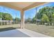 Covered patio overlooking a spacious backyard with a black metal fence at 500 Summit River Dr, Apopka, FL 32712