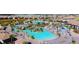 Aerial view of a community pool, lounging area, palm trees and landscaping, providing a resort-like living experience at 1077 Quaker Ridge Ln, Davenport, FL 33896
