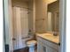 Well-lit bathroom featuring a shower-tub combination and a classic vanity with mirror at 1077 Quaker Ridge Ln, Davenport, FL 33896