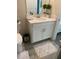 Bathroom with white vanity, ample counter space, and a stylish patterned rug at 1077 Quaker Ridge Ln, Davenport, FL 33896