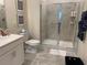 Bathroom featuring a toilet, single vanity, and glass door shower at 1077 Quaker Ridge Ln, Davenport, FL 33896