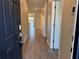 Inviting home hallway with tile flooring leading to an open living space and outdoor views at 1077 Quaker Ridge Ln, Davenport, FL 33896